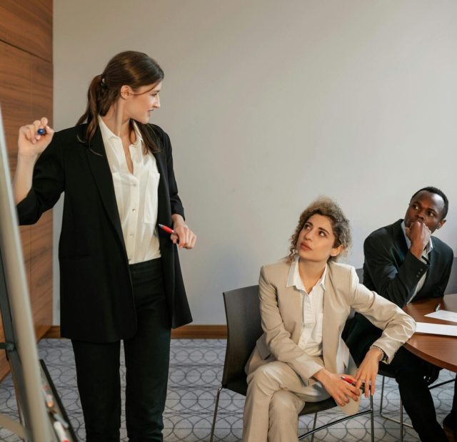 Group of diverse professionals engaging in a collaborative office meeting indoors.